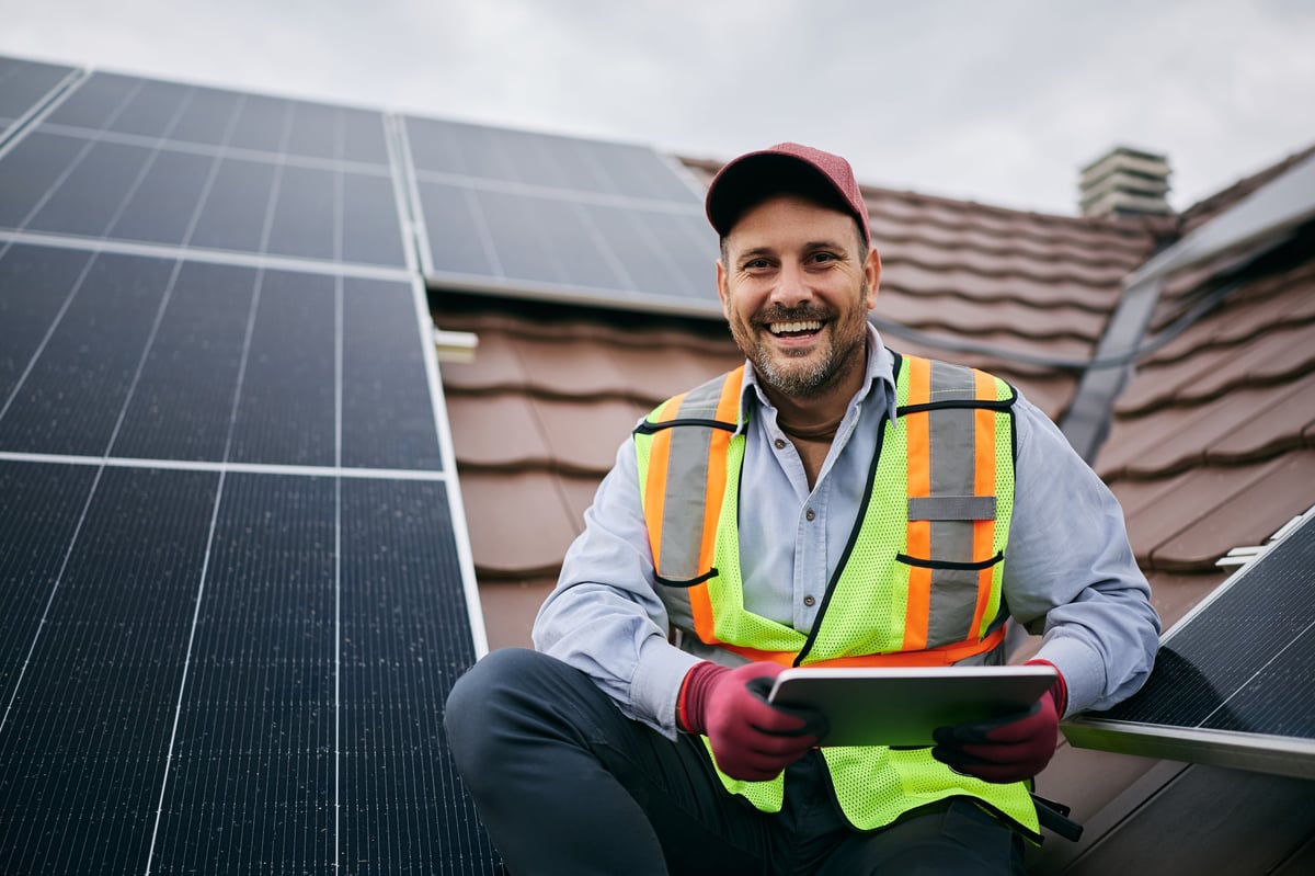 Solar engineer smiling on a rooftop installation